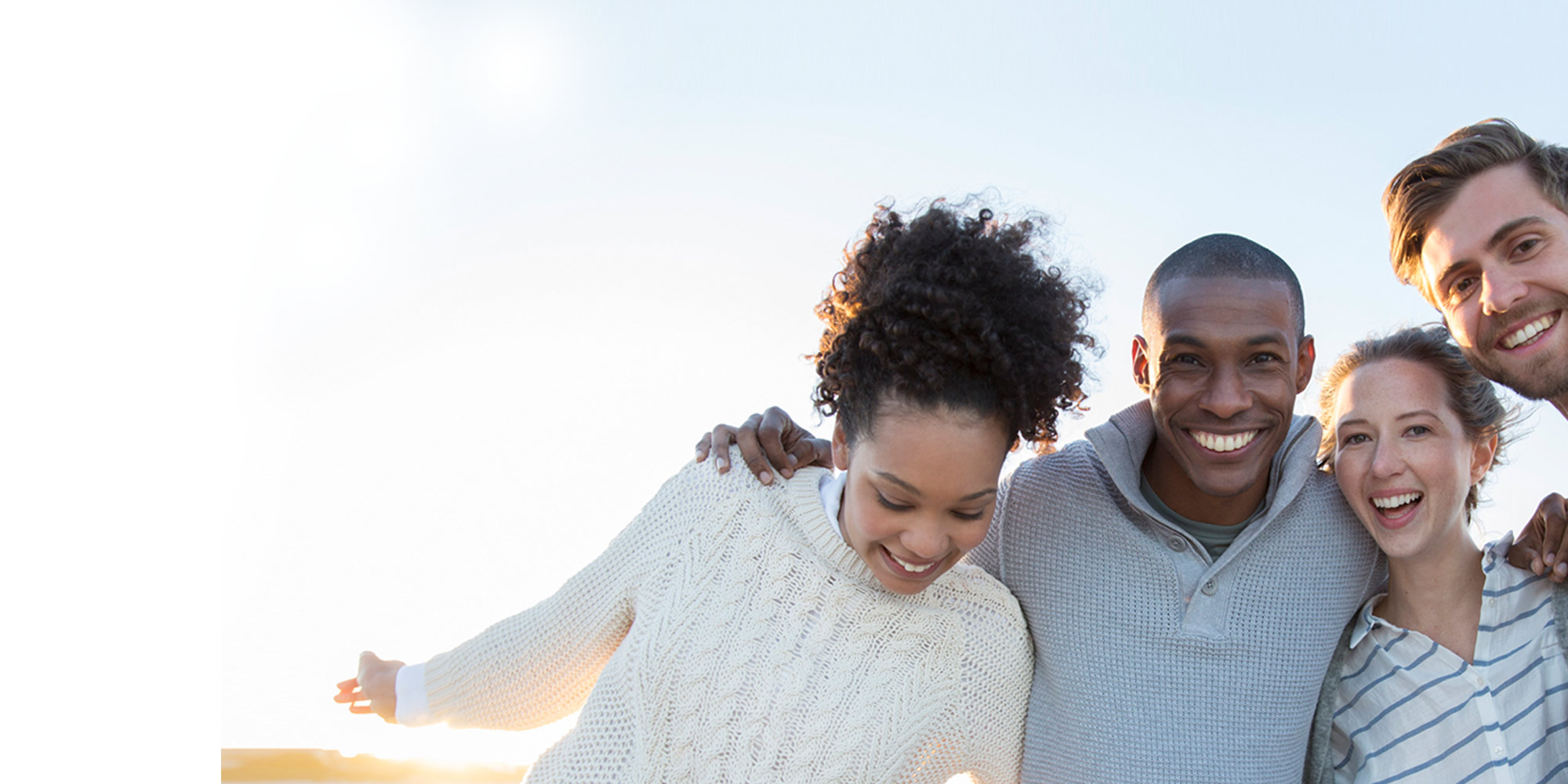 African American and Caucasian couple smiling at the camera