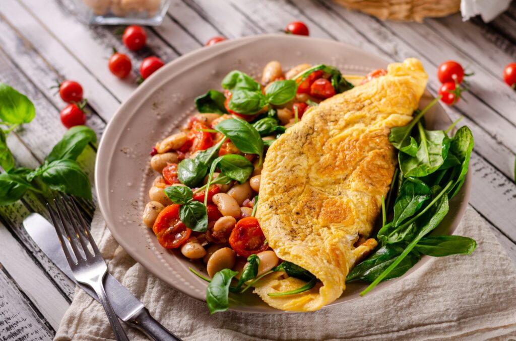 Heathy omelette with tomatoes, fresh herbs and beans, french onion